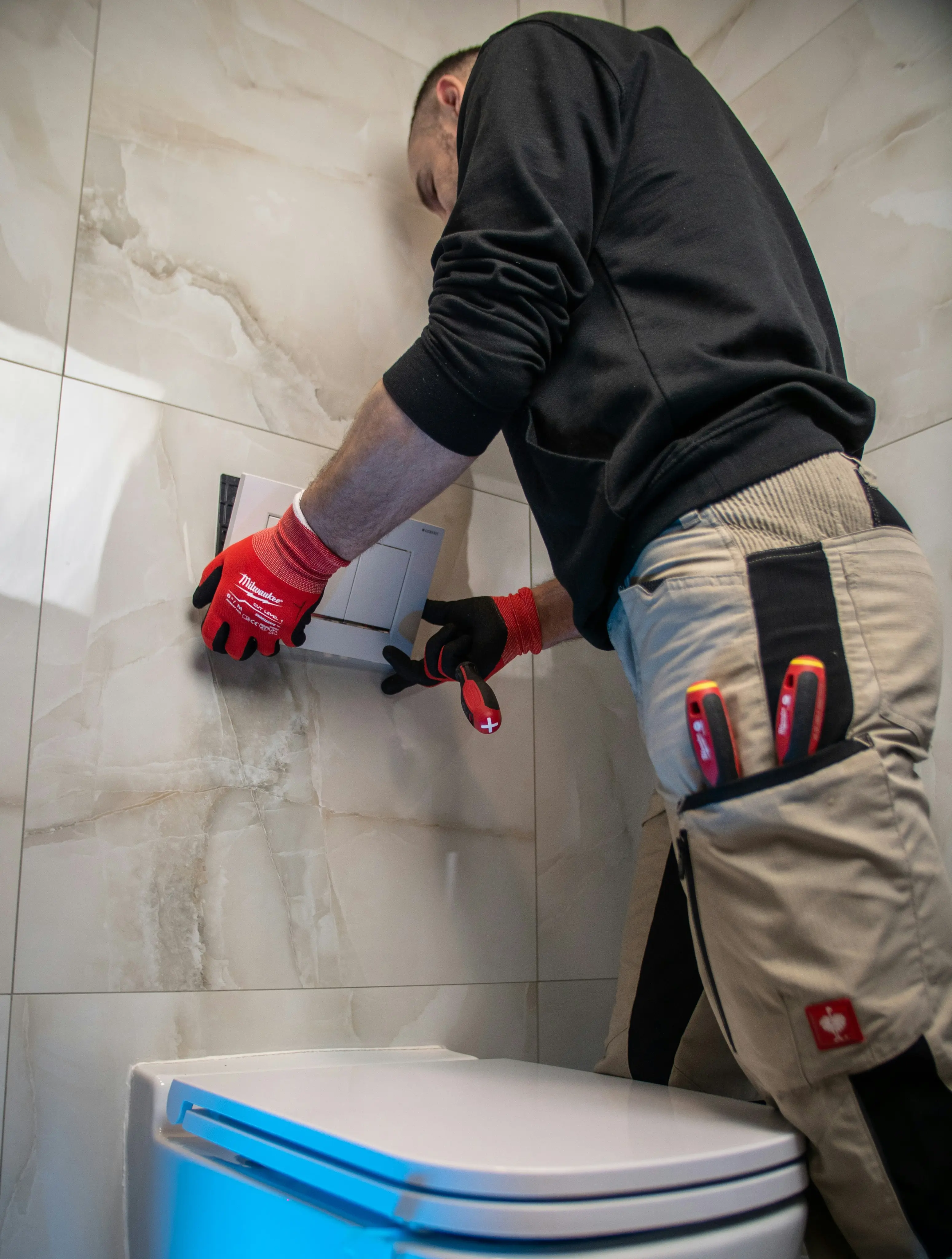 Plumber performing a commercial plumbing assessment