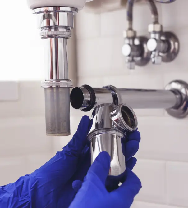 Plumber working on pipes