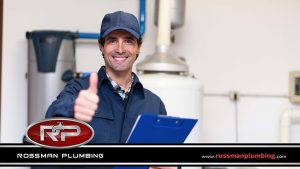 Smiling Technician Servicing a Hot-Water Heater