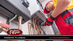 Plumber Checking Water Heater Leakage